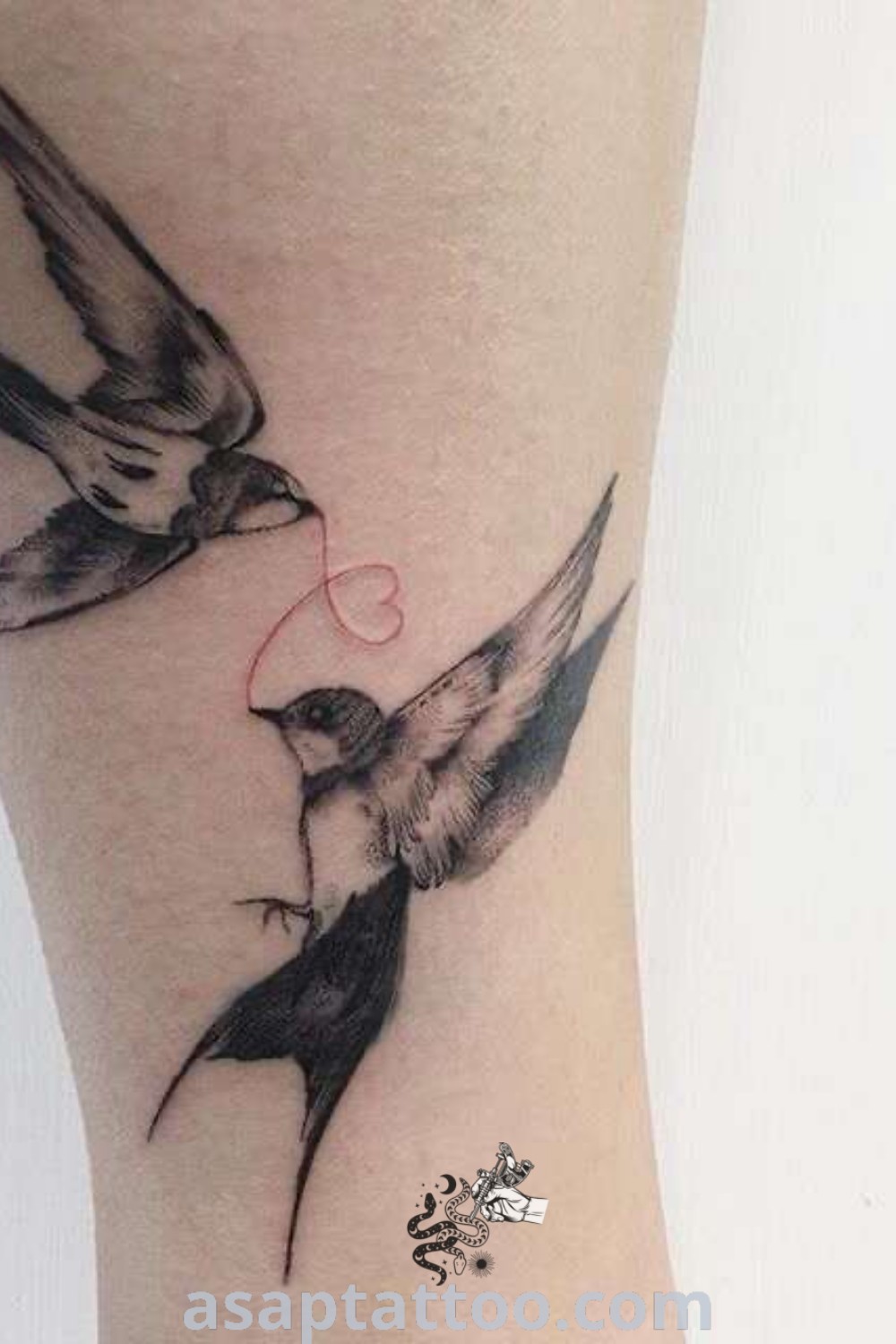 Lovebird tattoo featuring two birds flying next to a woman