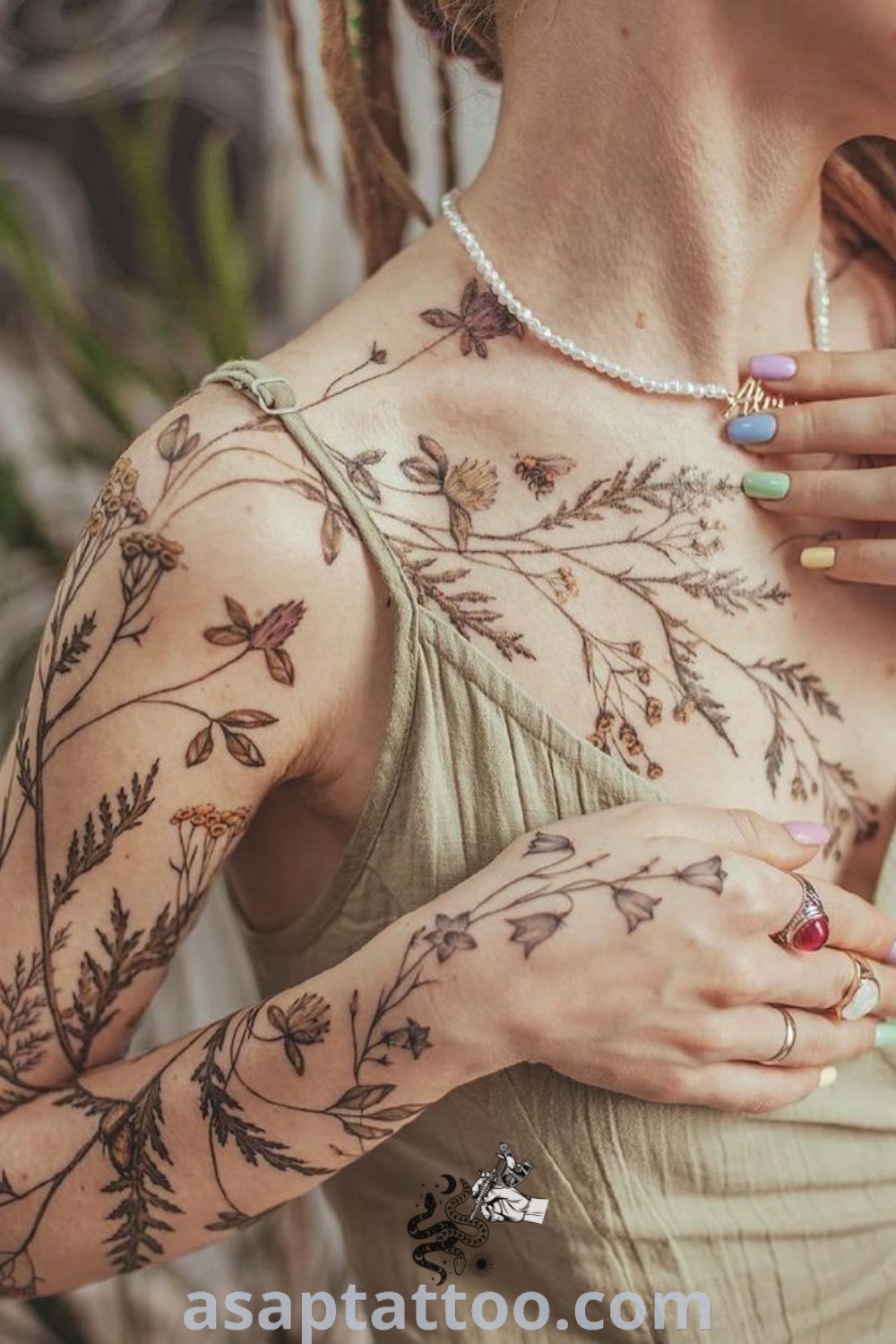 Botanical tattoo on a woman with beautiful floral and vine designs on her arms and chest, showcasing elegant tattoos that inspire you to get inked. Discover best tattoo ideas at asaptattoo.com.