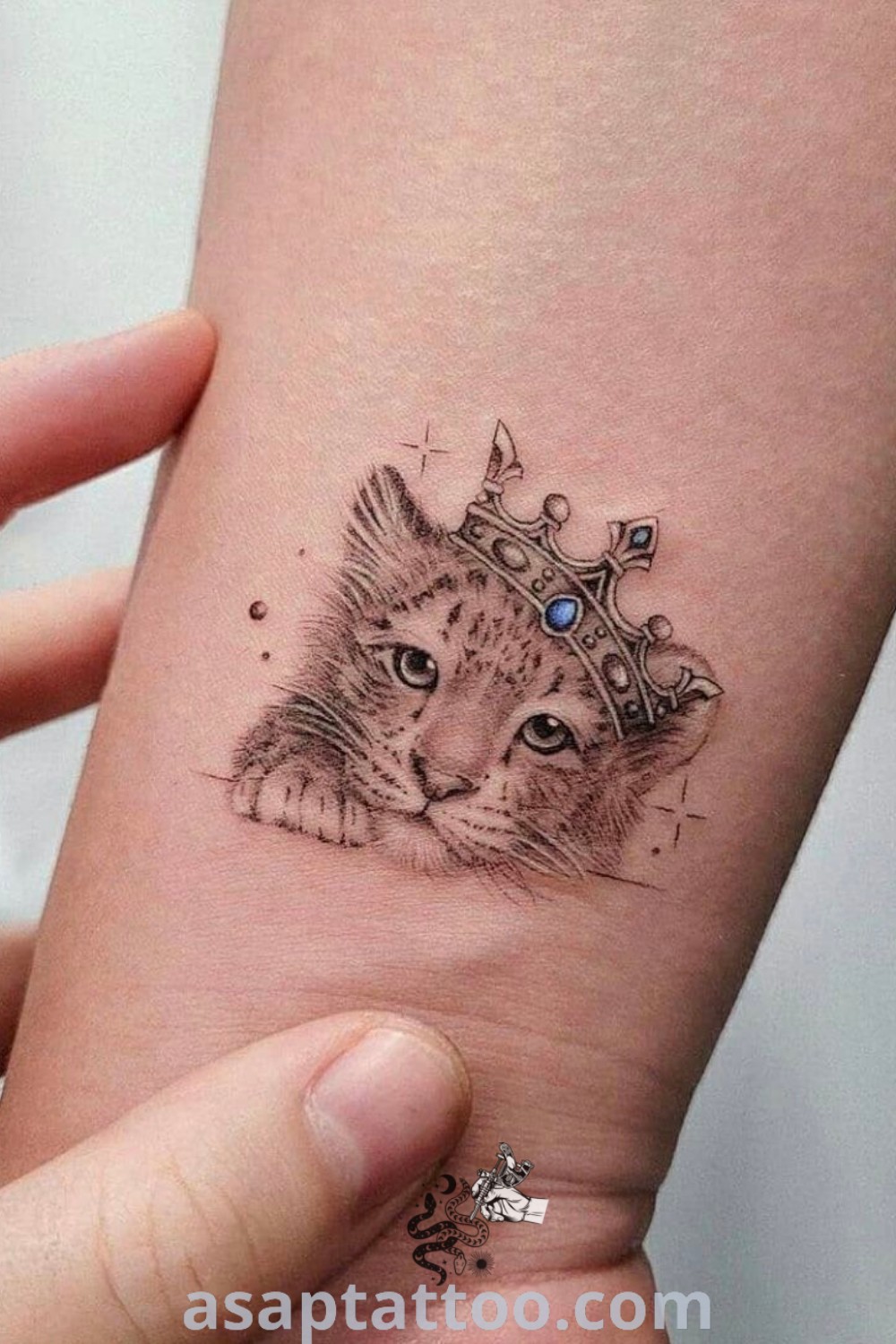 Cute cat with a crown tattoo design showcasing artistic features; combines elements of "Cubs Tattoo" and "Mom Tattoo Designs." A must-see for those looking for meaningful tattoos. Explore more ideas at asaptattoo.com.