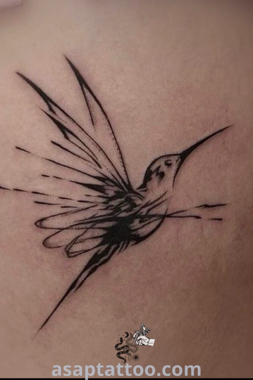 Small black and white hummingbird tattoo on a woman