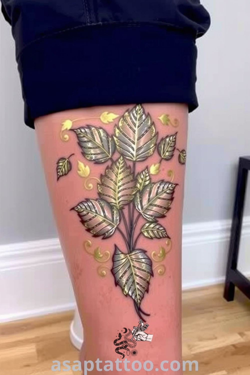 Metallic plants tattoo with gold and silver shimmering leaves, showcasing intricate linework and a lifelike texture. A gorgeous tattoo idea that will inspire you to get inked. asaptattoo.com