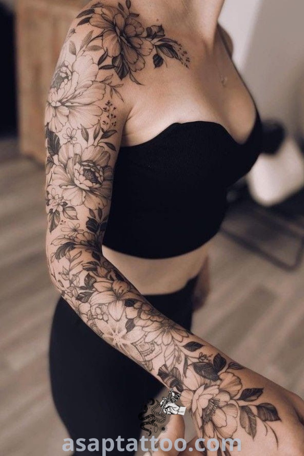 A woman showcasing beautiful shoulder sleeve tattoos, including floral designs and lighthouse motifs, highlighting elegant body art ideas. Discover more inspiration at asaptattoo.com.