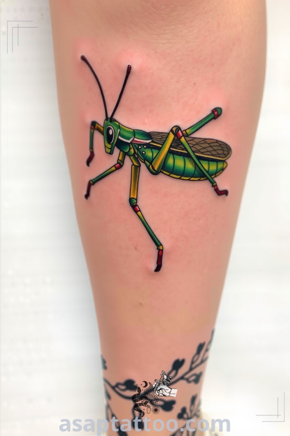 Surreal grasshopper tattoo with vibrant greens and yellows, featuring elongated limbs and intricate linework. A gorgeous tattoo that symbolizes transformation and resilience, showcasing artistic beauty that you must see. asaptattoo.com