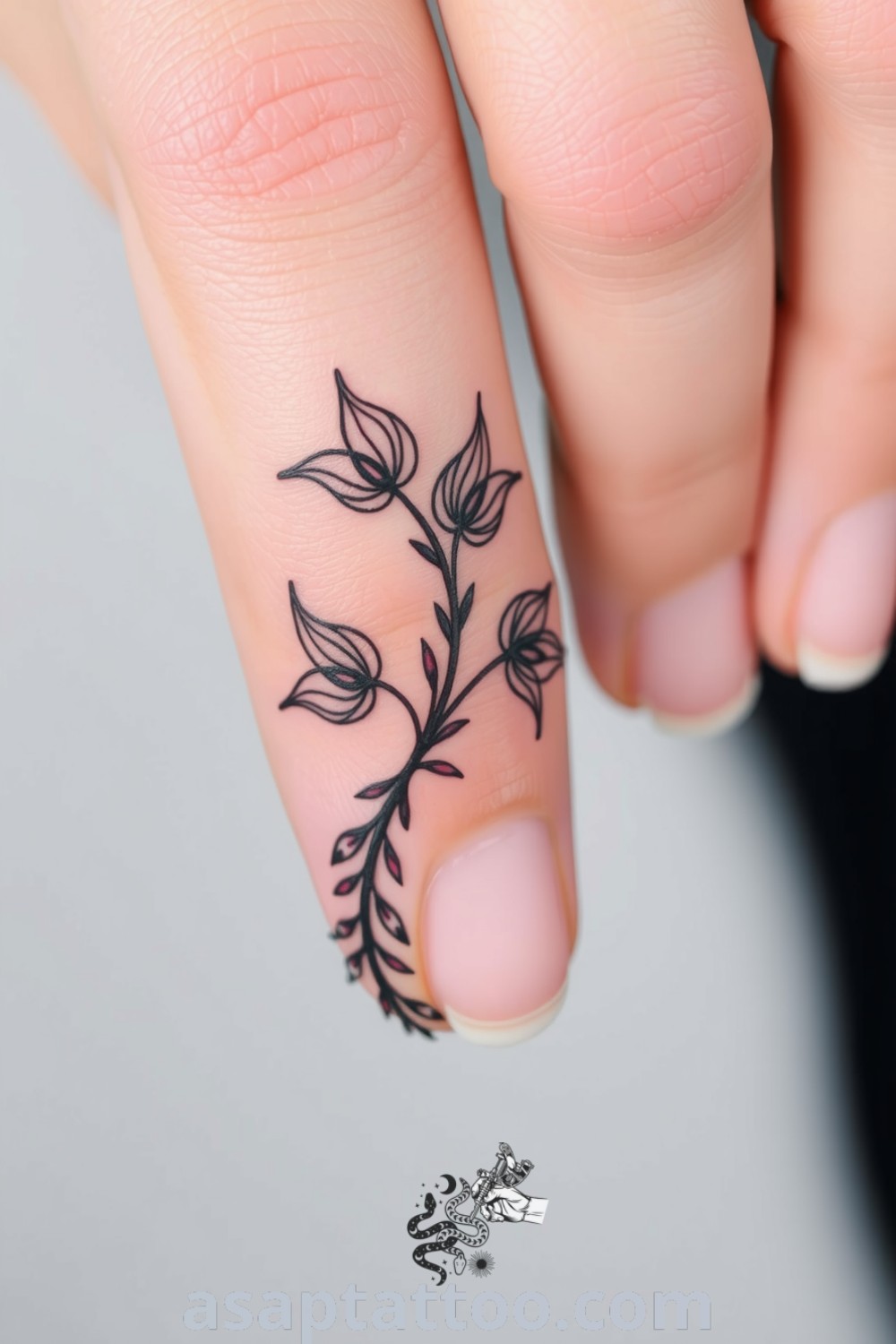 Intricate linework tattoo of intertwining plant motifs wrapping around a finger, showcasing varied line thickness for an elegant look. A gorgeous tattoo idea you must see to believe. asaptattoo.com
