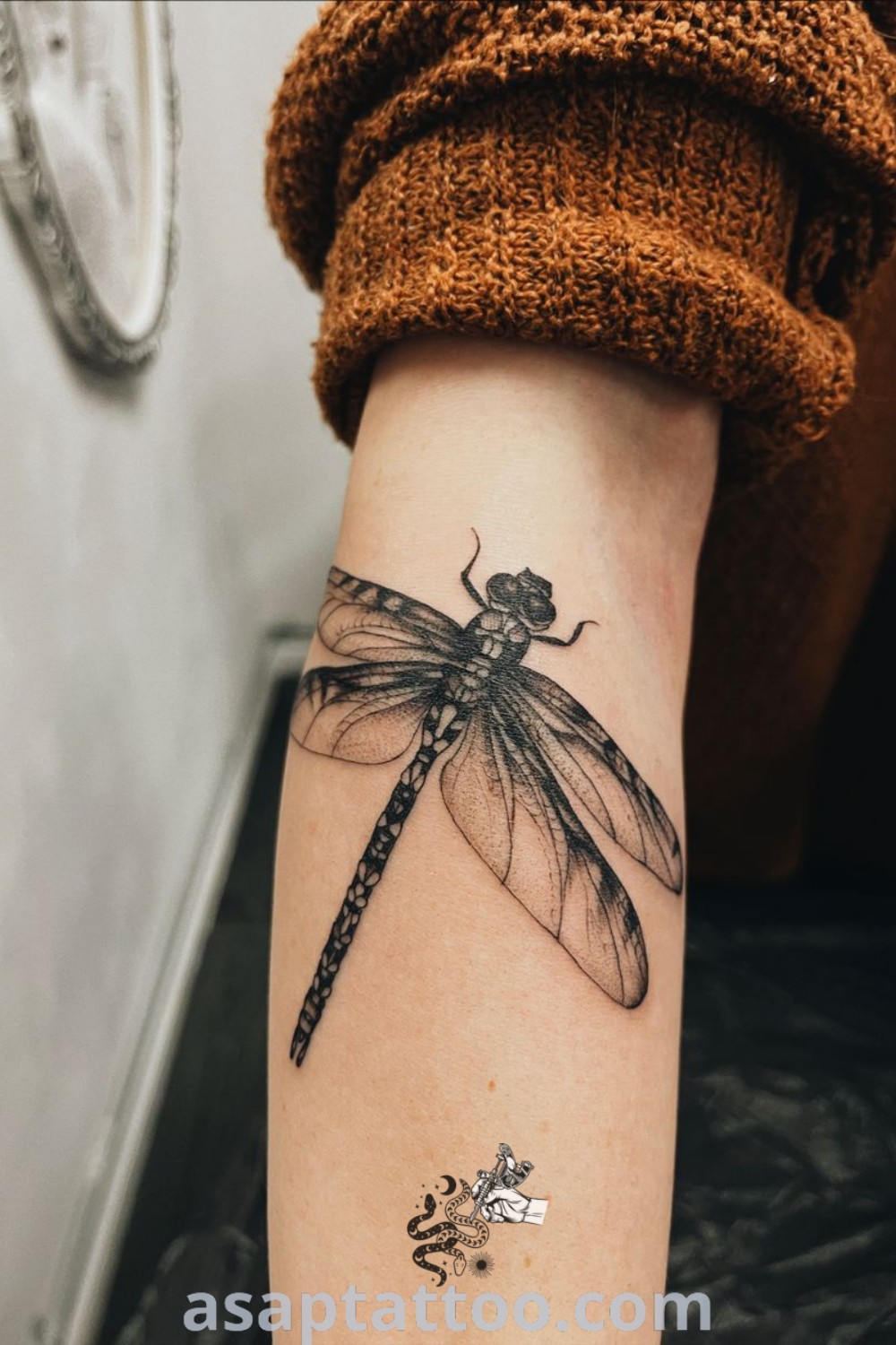 Elegant dragonfly tattoo on a woman