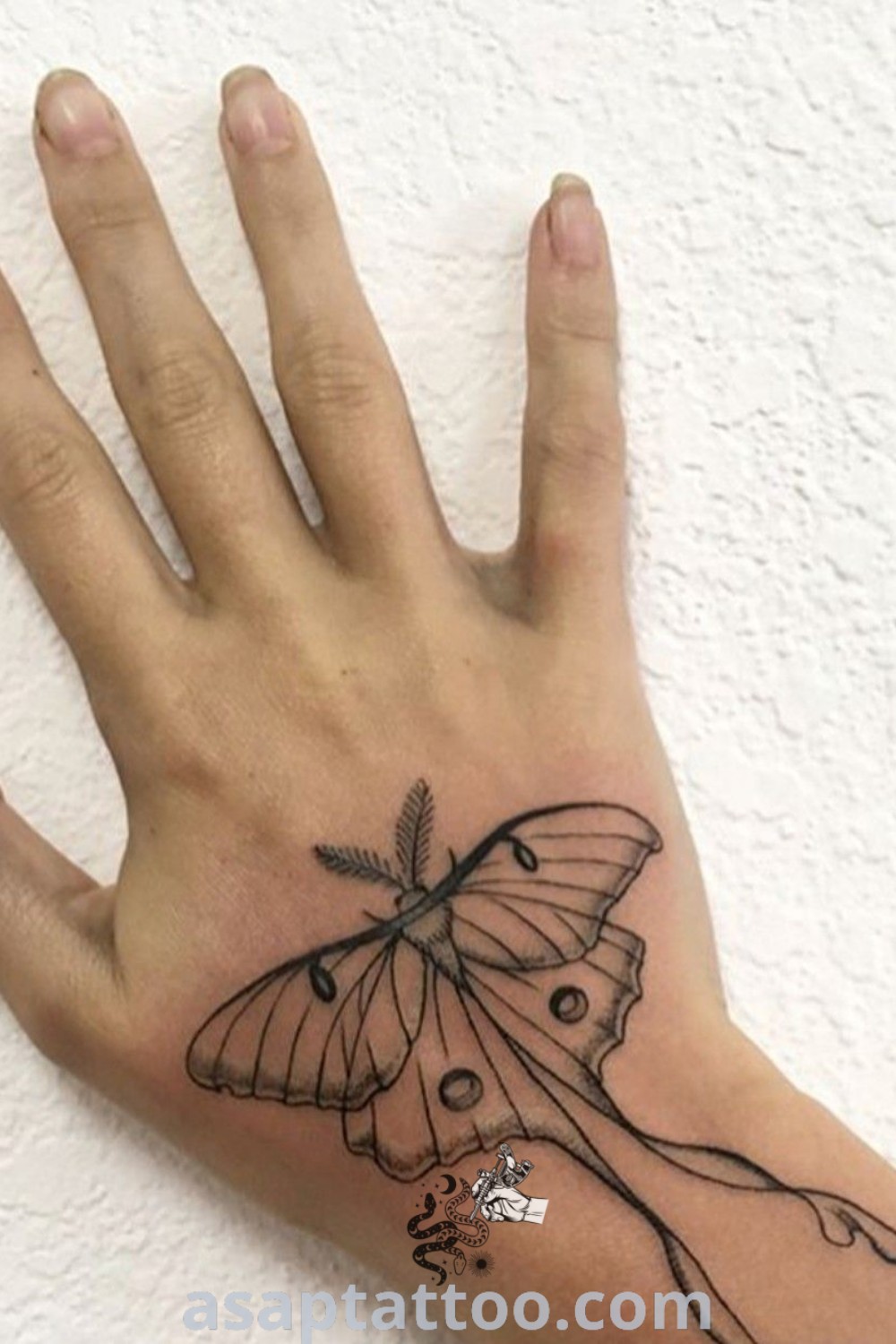 Fine line moth tattoo on a hand showcasing elegant and cute insect art. A stunning addition for those exploring tattoo designs with meaning. Discover more at asaptattoo.com.