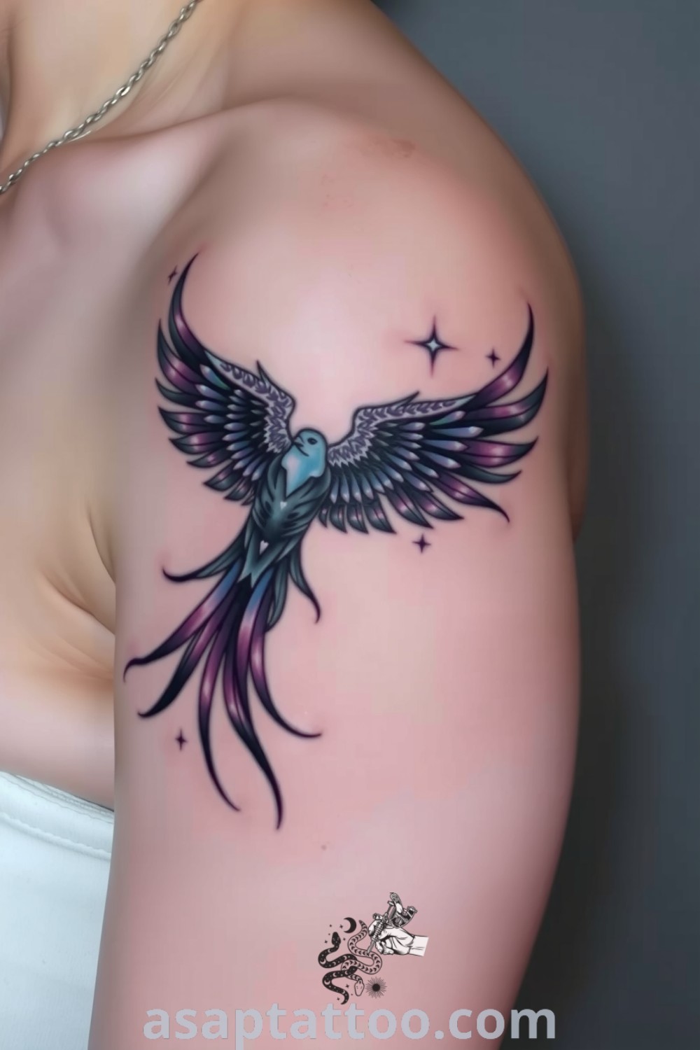 Celestial bird tattoo with intricate linework and deep blues and purples, radiating a sense of movement against light skin. An elegant tattoo design you must see to believe. asaptattoo.com