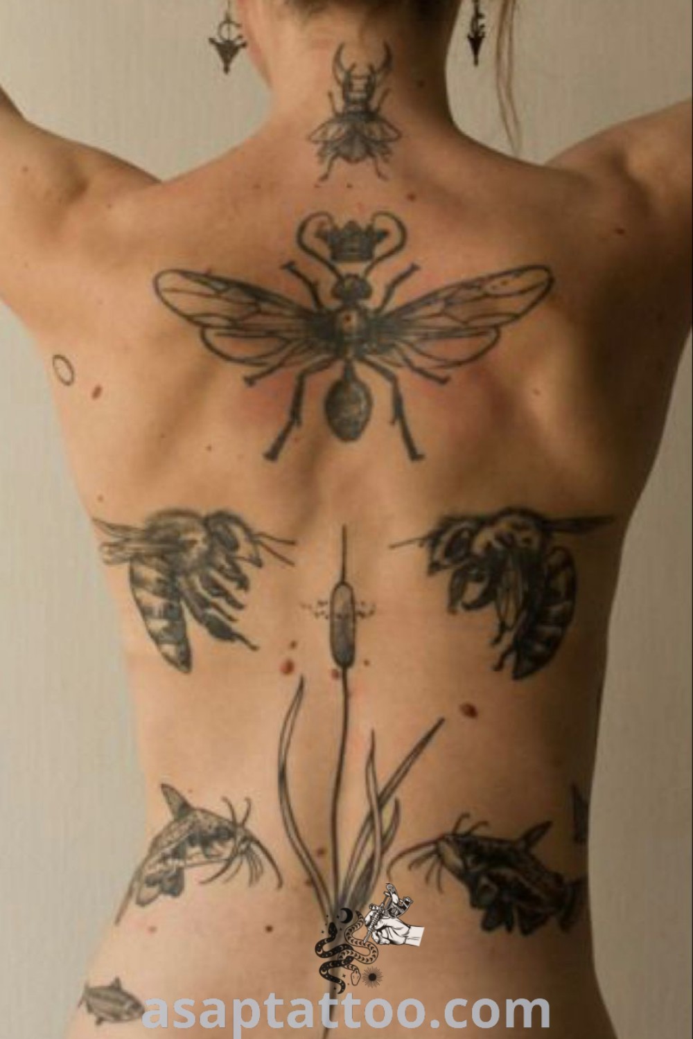 Back of a woman’s body with tattoos on her chest, featuring intricate henna and bee designs. A perfect inspiration for those seeking elegant back tattoos and artistic skin art. Explore more at asaptattoo.com.