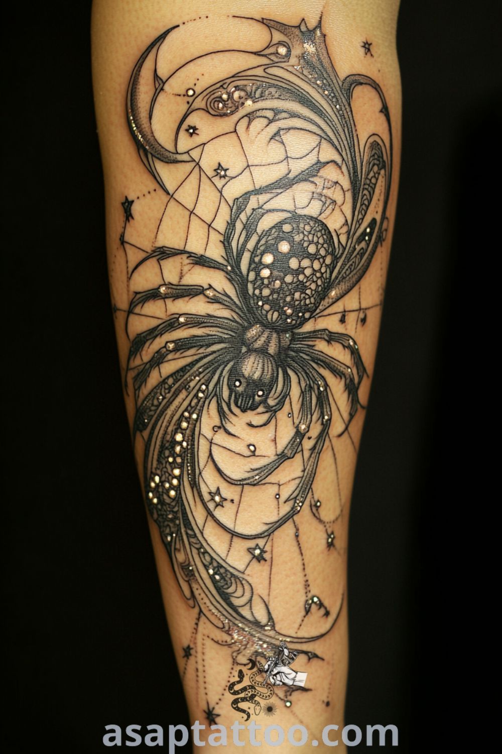 Celestial spider tattoo in deep blacks and rich grays with intricate web design, stars, and crescent moons. A gorgeous tattoo idea that will inspire you to get inked. asaptattoo.com