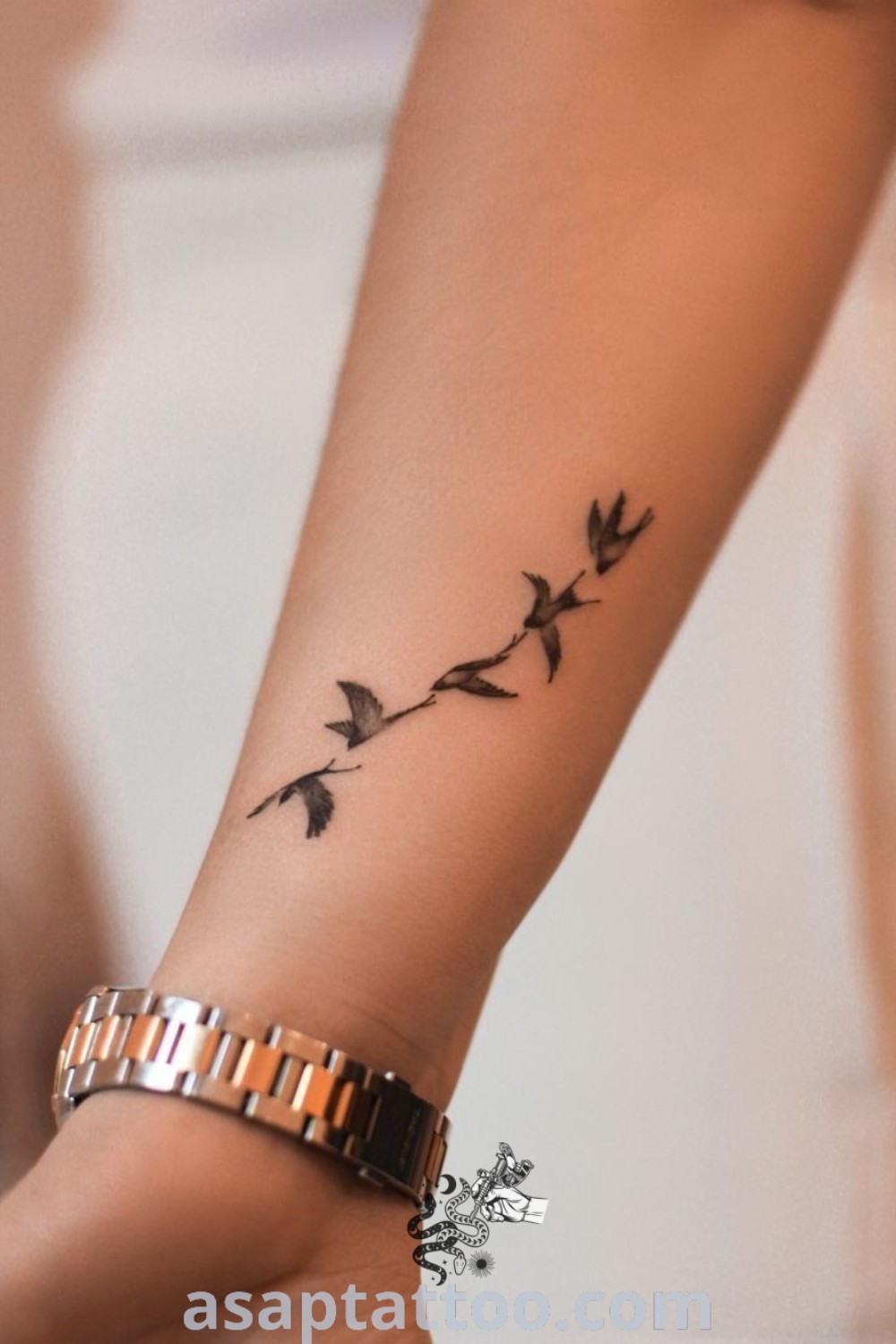 Elegant simple armband tattoo featuring little bird tattoos and rose tattoos for women. A stylish design that embodies artistic charm, perfect for those seeking gorgeous tattoos to decorate their body with. Discover more at asaptattoo.com.