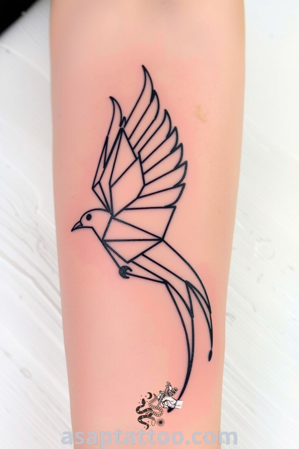 Geometric bird tattoo on forearm with intricate sharp lines and fluid shapes, showcasing depth and elegance. This amazing tattoo idea will inspire you to get inked. asaptattoo.com