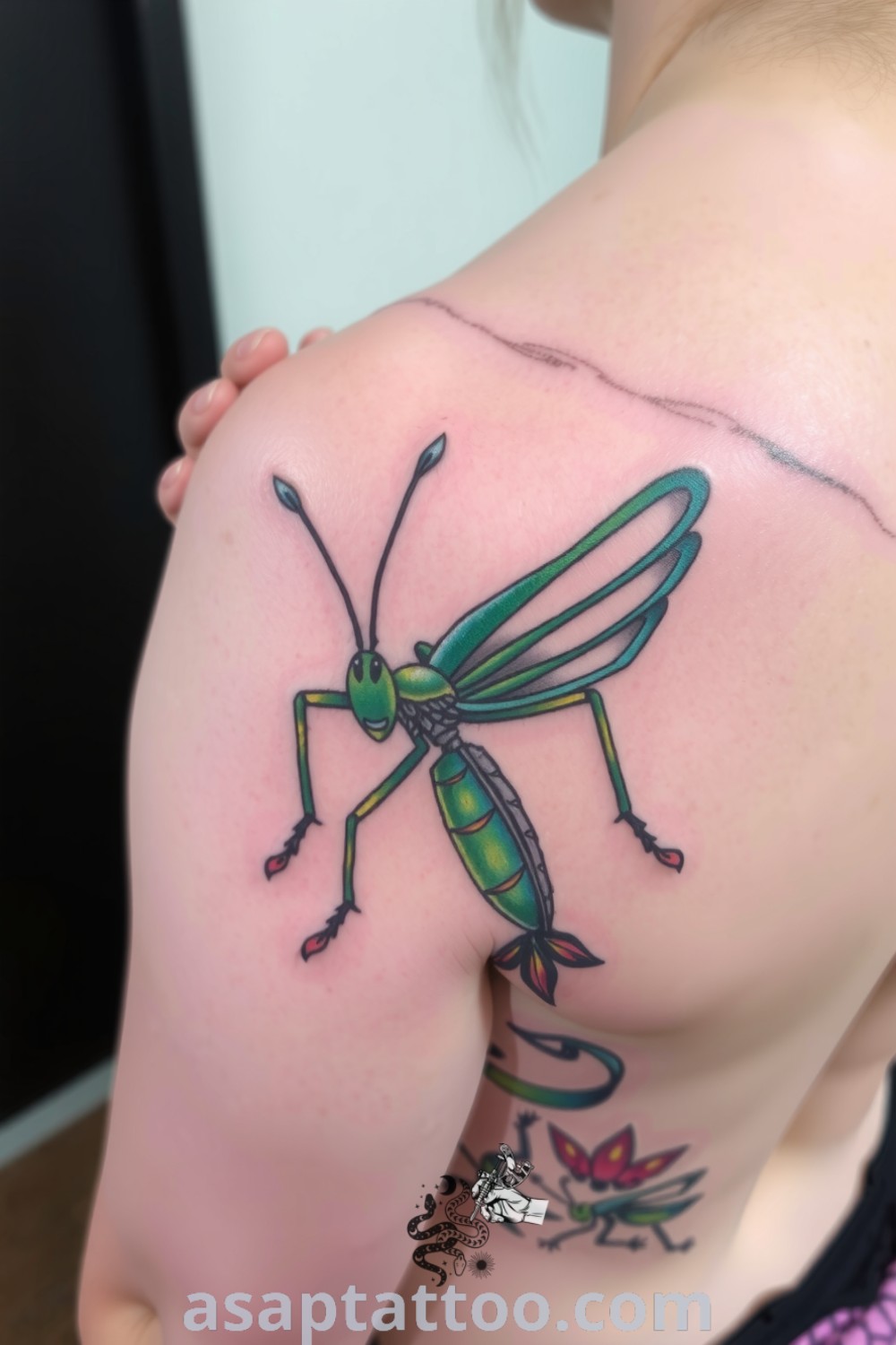Fantasy grasshopper tattoo on upper back with intricate linework, vivid green and blue colors, and beautiful gradients. A gorgeous tattoo idea you must see to believe that inspires transformation. asaptattoo.com