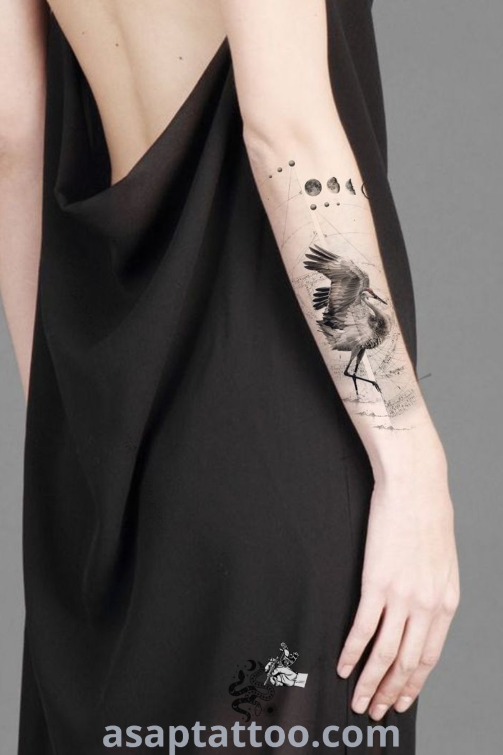 A woman with a bird tattoo on her arm against a skull background, showcasing black work artistry. Inspiring tattoo design that combines elegance with personal meaning, perfect for those exploring tattoo ideas at asaptattoo.com.