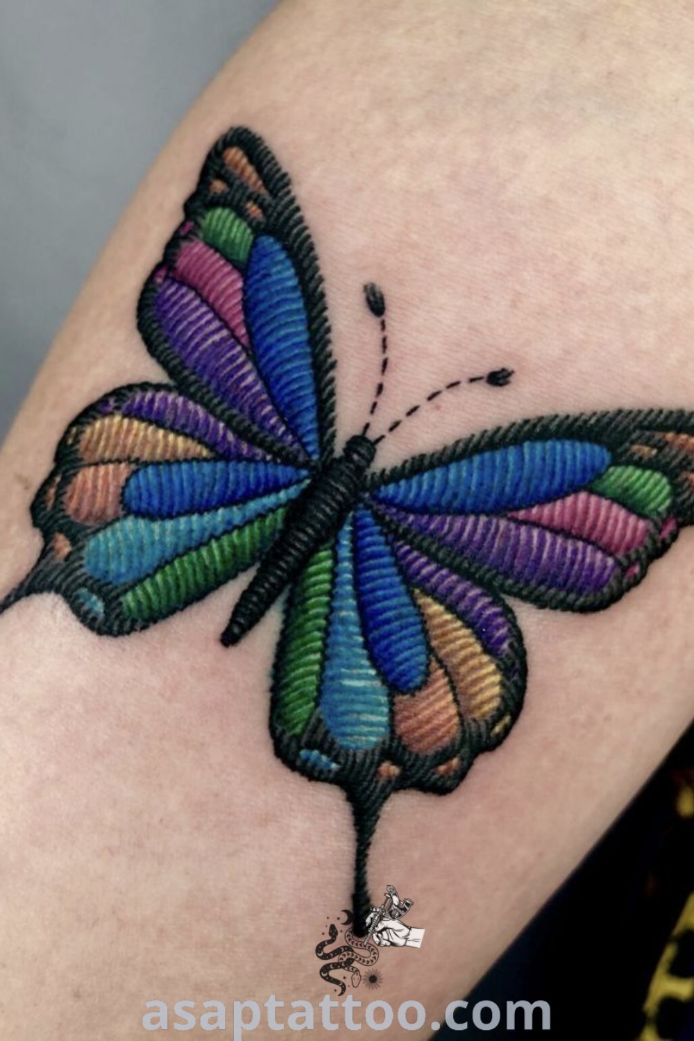 Colorful embroidered butterfly tattoo showcasing fabric tattoo design and vibrant hues, perfect for tattoo enthusiasts. Discover amazing embroidery tattoo ideas at asaptattoo.com.