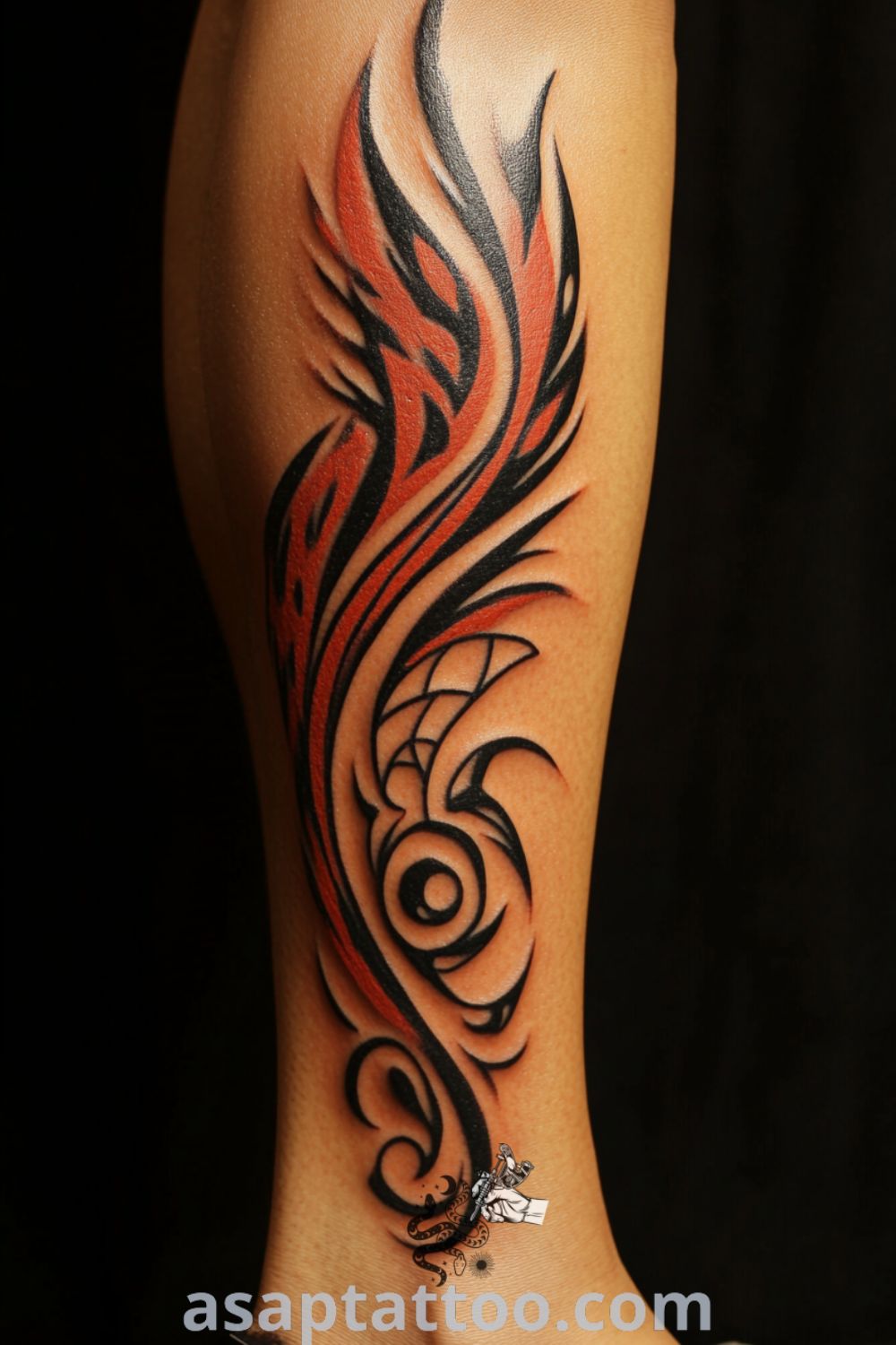 Tribal phoenix tattoo on the calf featuring intricate linework in red and orange, symbolizing rebirth and strength. A gorgeous tattoo idea you must see to believe. asaptattoo.com