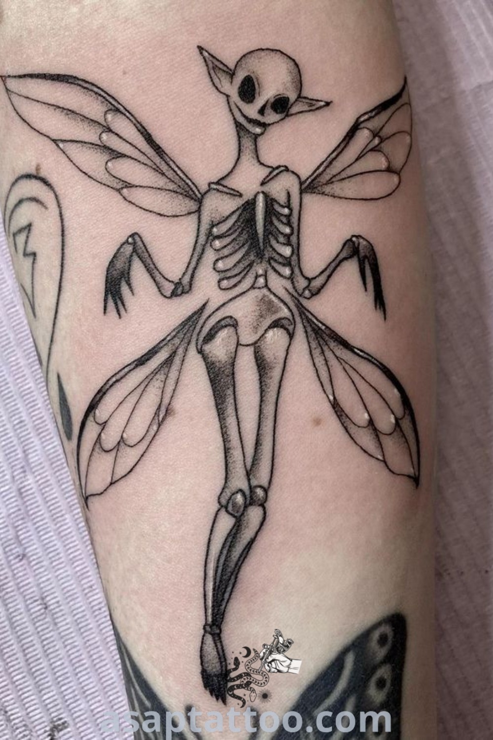 Grunge tattoo of a skeleton flying through the air, showcasing a creative and gothic design. An inspiring piece for those seeking artistic tattoos with meaning. Explore more at asaptattoo.com.