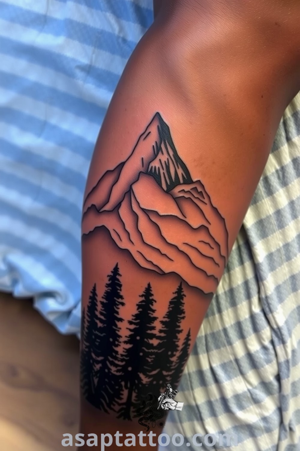 Intricate mountains and forest tattoo designed with fine linework and soft gradients, offering a dynamic interplay of light and shadow. A gorgeous tattoo inspiration you must see to believe. asaptattoo.com