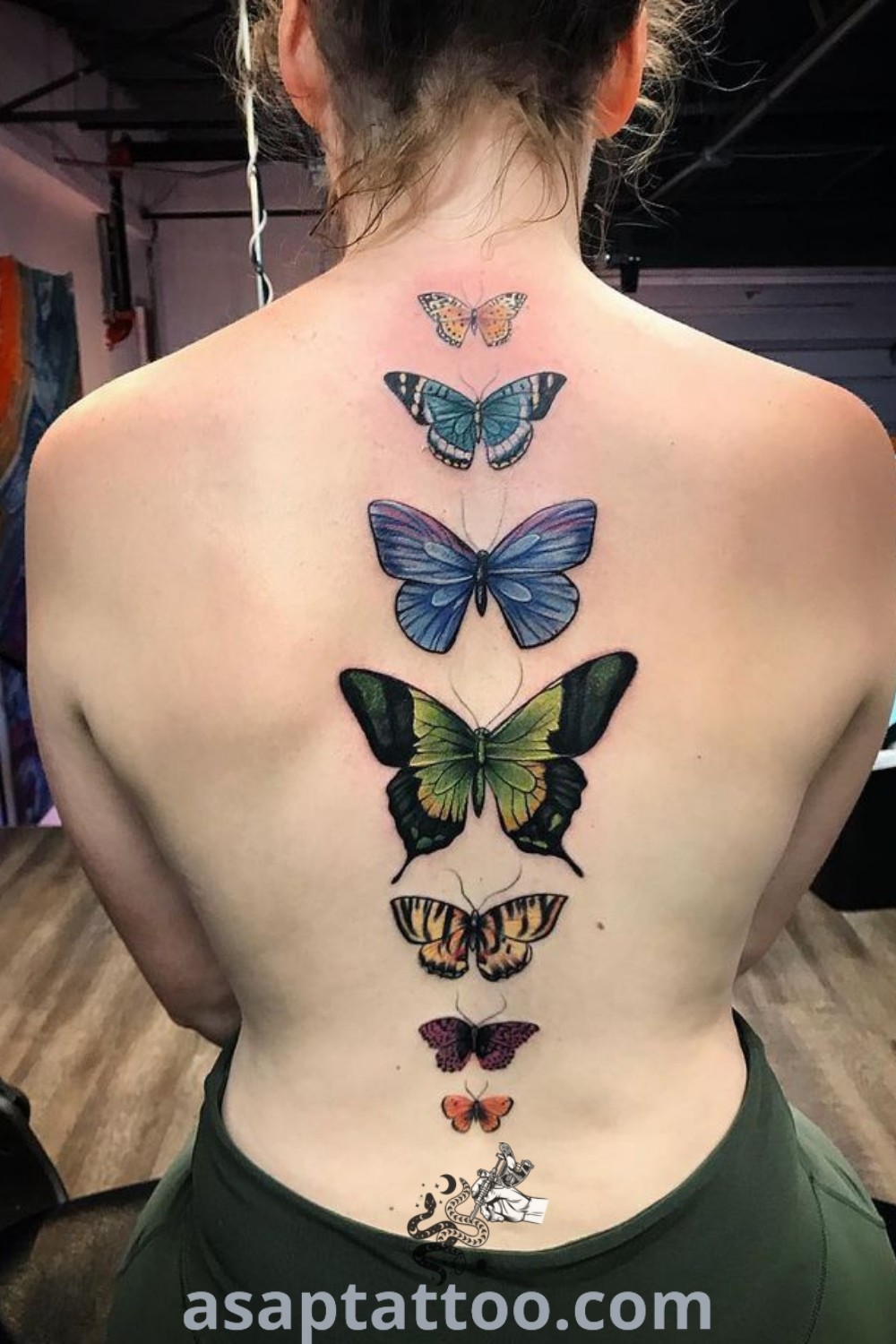 Elegant butterfly tattoos on the back of a woman