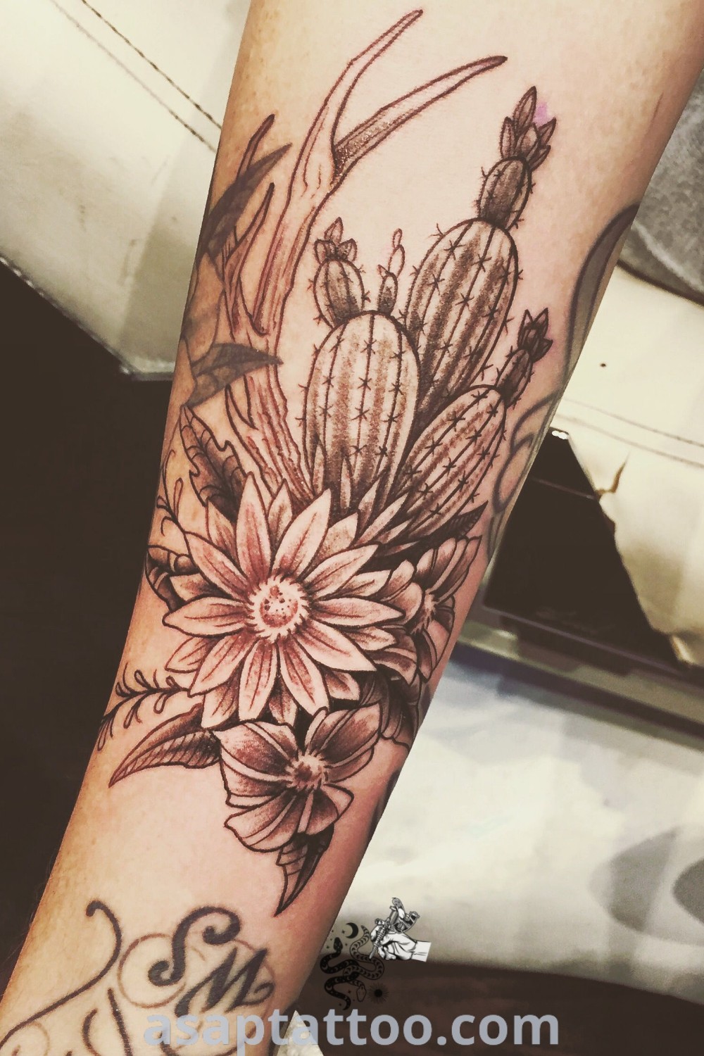 Cactus and wildflower tattoo showcasing a southwestern design, perfect for women looking for elegant tattoos. A beautiful example of desert floral tattoos and southwestern tattoo sleeves available at asaptattoo.com.