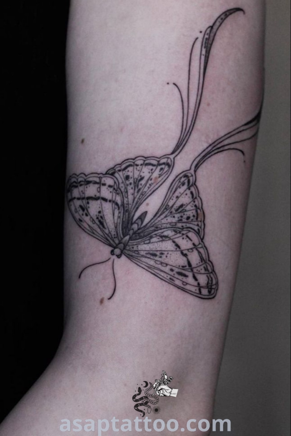 Elegant lunar moth tattoo in black ink on the left upper and lower arm. A stunning design for tattoo lovers, showcasing artistic features and abstract beauty. Explore best tattoo ideas you must see to believe at asaptattoo.com.