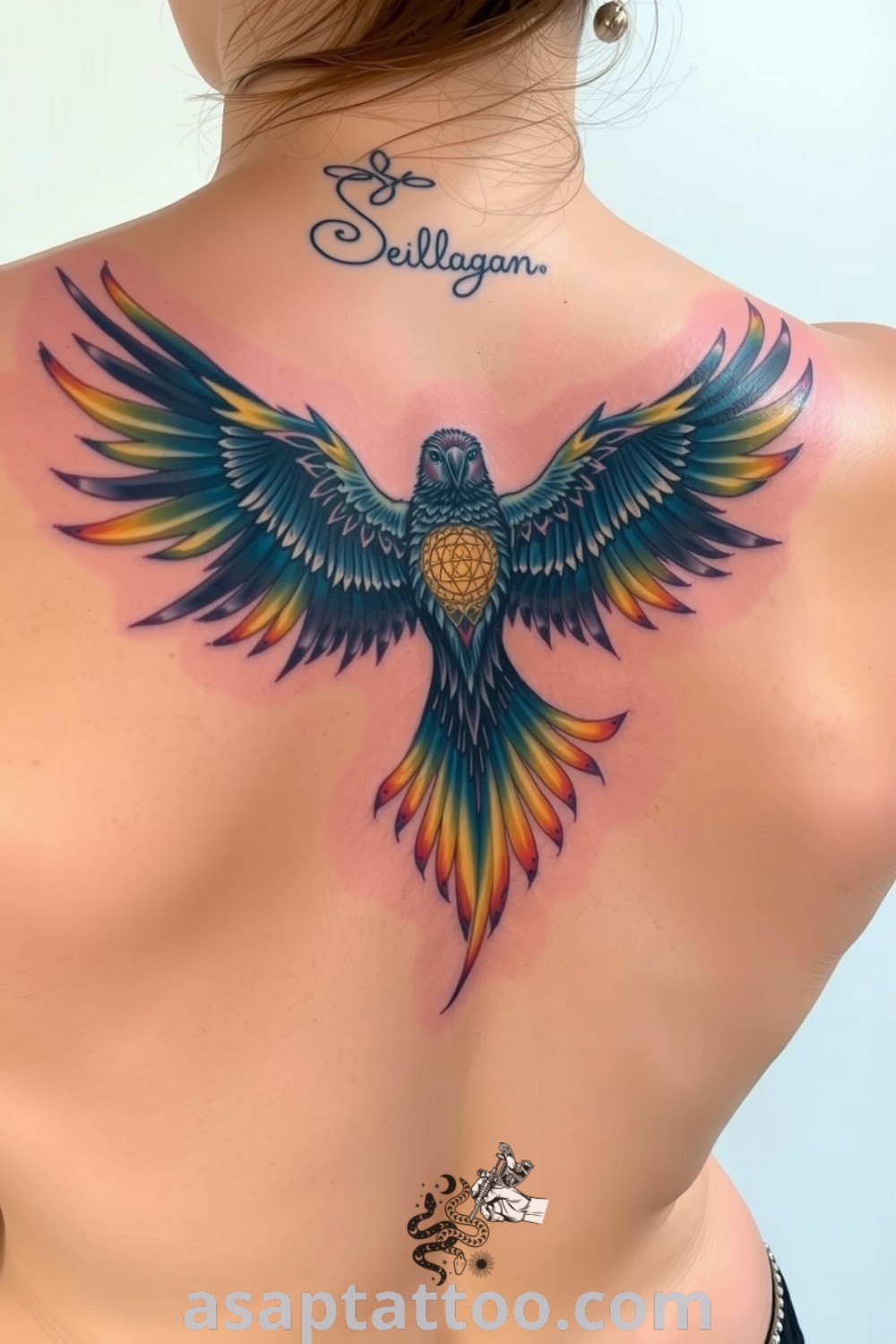 Celestial bird tattoo on the upper back with vibrant blue and gold gradients, featuring intricate linework and a sense of movement. An amazing tattoo idea you will absolutely love. asaptattoo.com