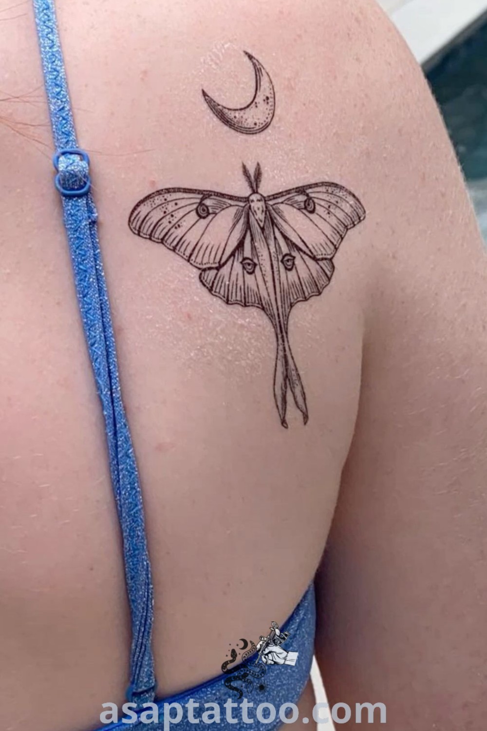 Lunar moth tattoo on the back of a woman