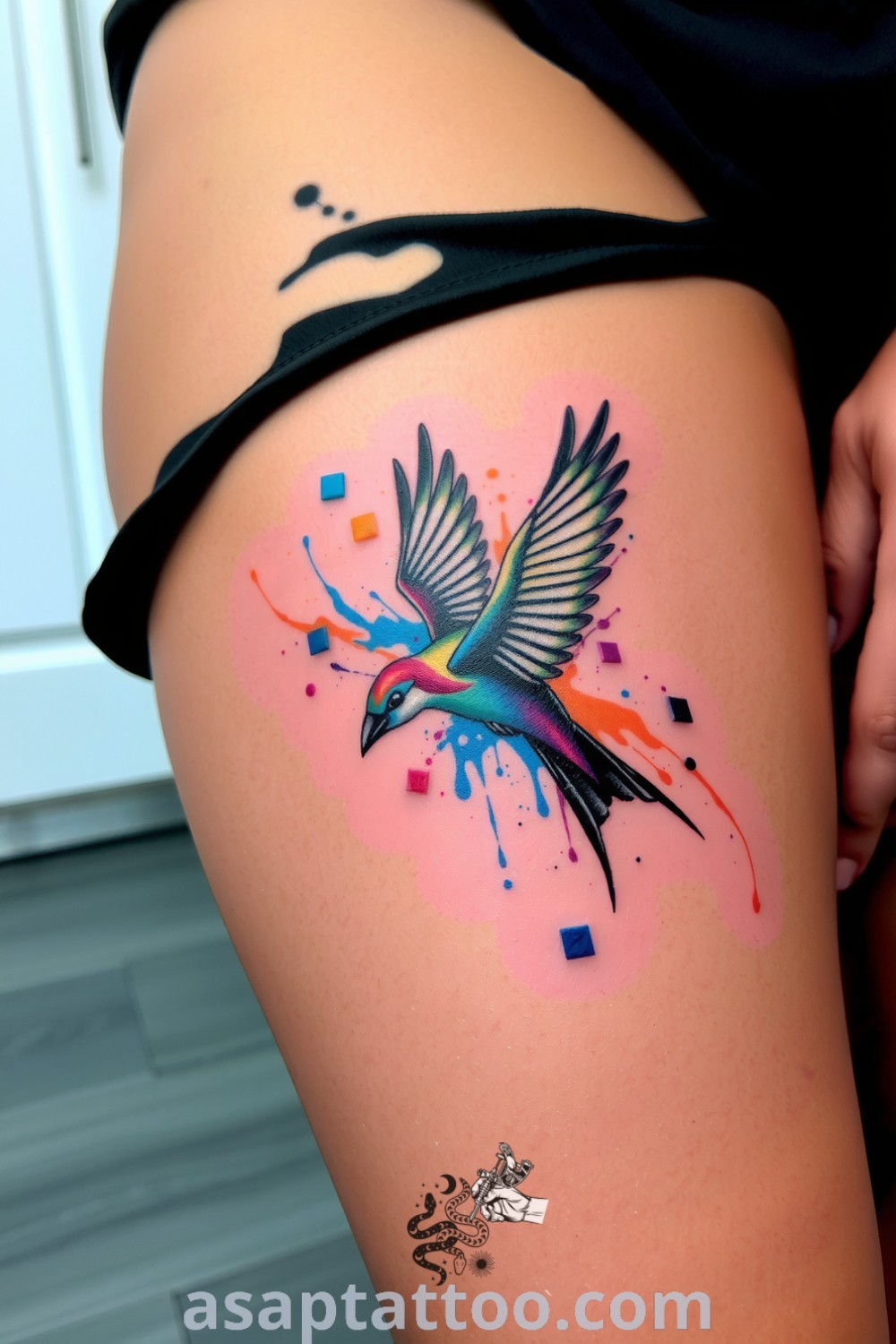 An enchanting ink splash bird tattoo featuring vibrant colors and intricate linework, creating a dynamic and lively design. A gorgeous tattoo idea you must see to believe. asaptattoo.com