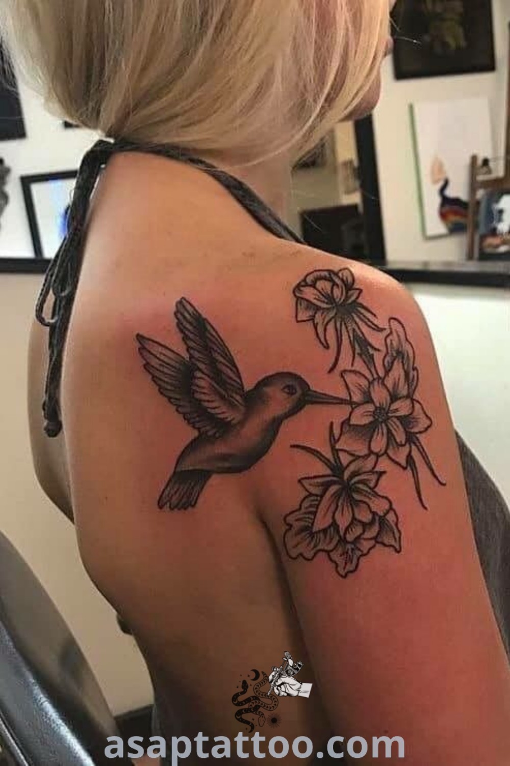 Stylish bird and flower tattoo on a woman