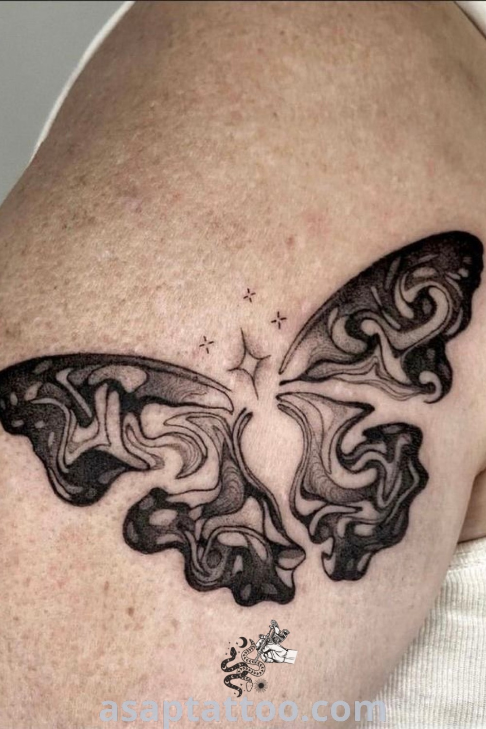 Black and white butterfly tattoo on a man