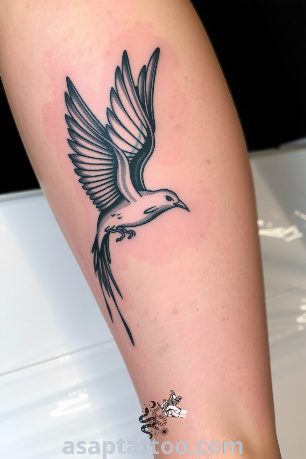 Chiaroscuro bird tattoo with deep blacks and soft greys, showcasing intricate detail and a dynamic movement that emphasizes freedom. A gorgeous tattoo idea that will inspire you to get inked. asaptattoo.com