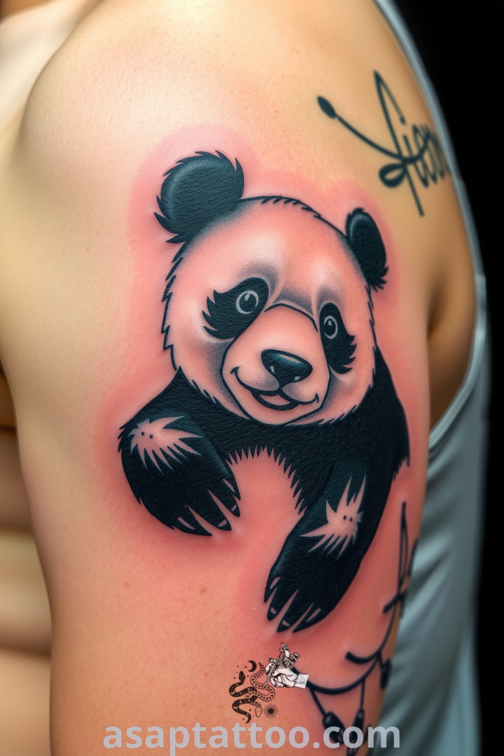 Blackwork panda tattoo on upper arm with intricate linework and deep ink saturation. A gorgeous design that will inspire you to get inked. asaptattoo.com