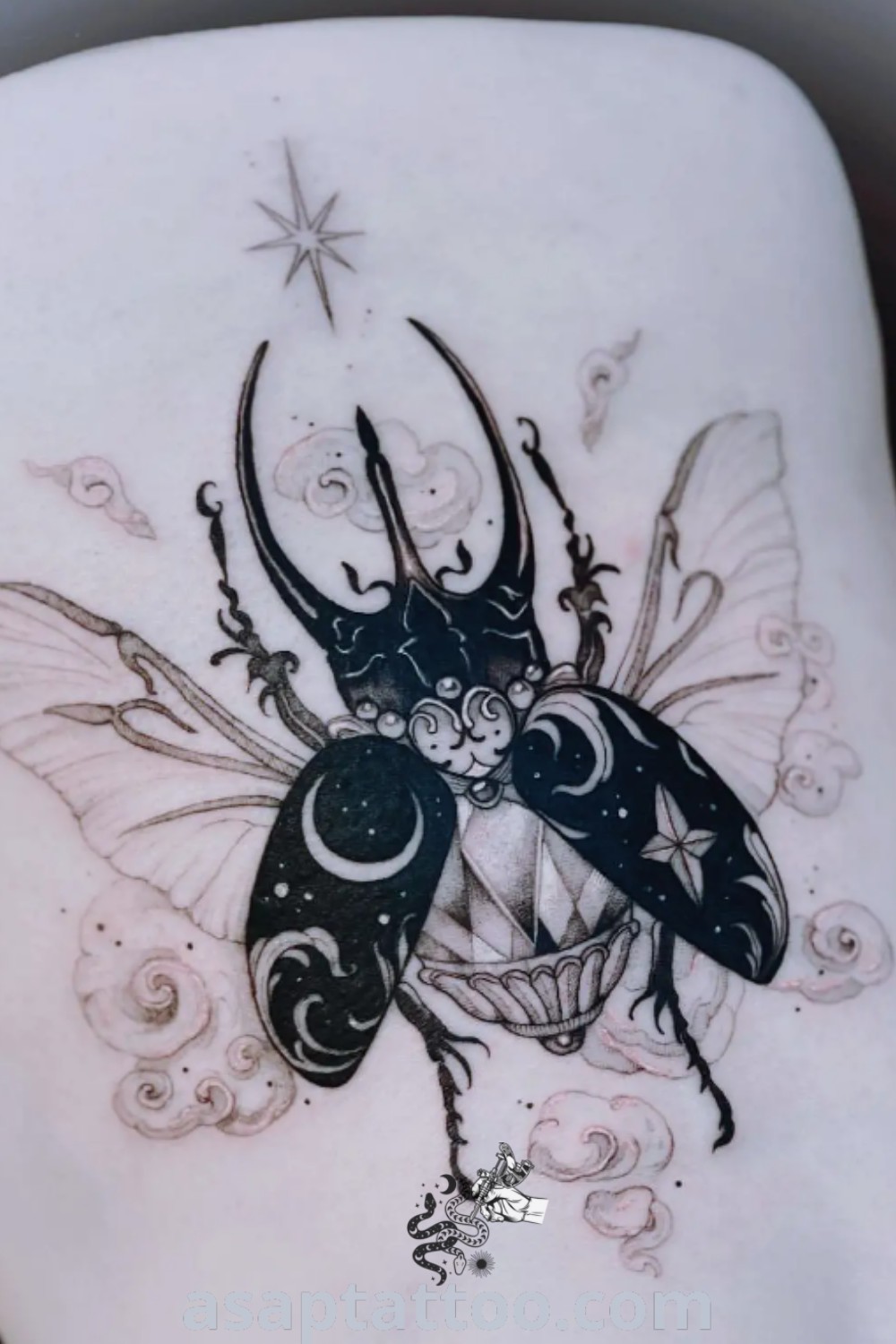 Elegant scarab beetle tattoo design featuring a woman